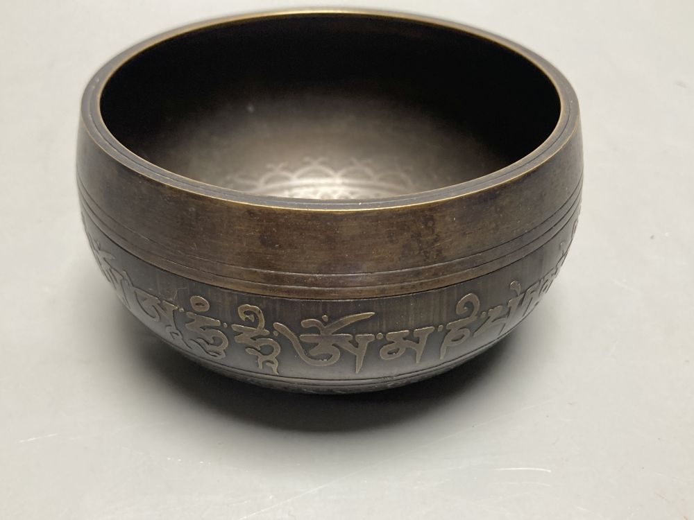 An Islamic small bronze circular bowl, with engraved decoration and Arabic script, Dia 11cm